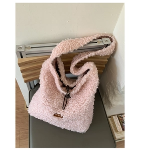 Close-up of pink fuzzy tote bag showing soft lamb wool texture and drawstring closure