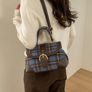 Retro plaid crossbody bag detail showing leather trim and adjustable shoulder strap