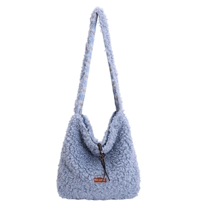 Light blue faux shearling tote bag with leather label and brown drawstring closure