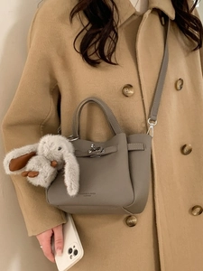 Elegant grey litchi grain leather bucket bag with a cute rabbit pendant accessory