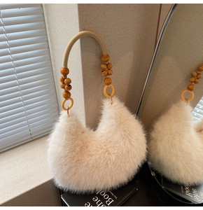 Detail of white faux fur handbag featuring unique wooden bead handles and woven rope
