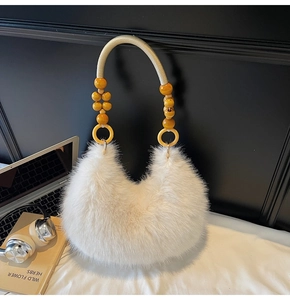 Detail of white faux fur bag with woven rope handle and yellow wooden beads accents