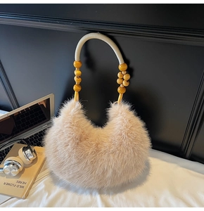 Detailed close-up of fluffy faux fur handbag featuring wooden bead handle and braided rope