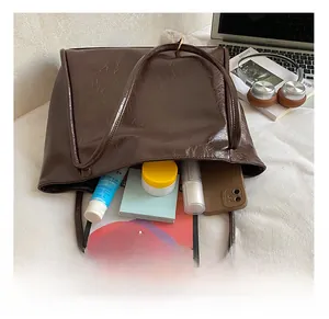 Deep brown leather tote bag interior showing capacity for tablet and daily items