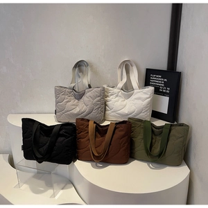 Quilted tote bags display in grey, white, black, brown, and olive green colors
