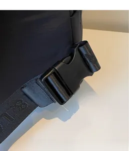 Detail of durable black plastic buckle and high-density jacquard strap on nylon backpack