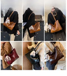 Detail view of large soft leather tote bag with plush rabbit charm in various colors