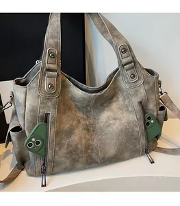 Detail of vintage gray tote bag showing front double zipper pockets and soft faux leather texture