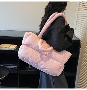 Pink quilted down tote bag shoulder wear detail showing large size and puffy texture