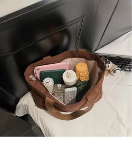 Detail view of large interior storage capacity in a coffee brown quilted tote bag