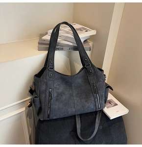 Detailed view of dark grey vintage tote bag featuring textured faux leather and zippers