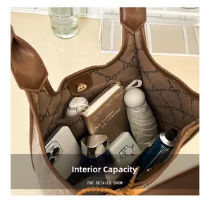 Detailed interior of the large brown tote bag showing capacity and zip pocket