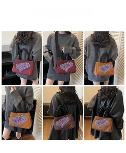 Détails des lettres brodées sur des sacs à main en peluche disponibles en plusieurs coloris