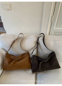Detailed view of vintage suede tote bags in brown and dark coffee with belt buckle straps