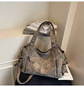 Detailed view of the vintage taupe tote bag with matte texture and dual zipper pockets