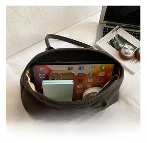 Macro detail of spacious interior in coffee brown suede tote bag for daily office essentials