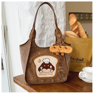 Detailed texture of brown corduroy tote bag with cute dog patch and leather handle