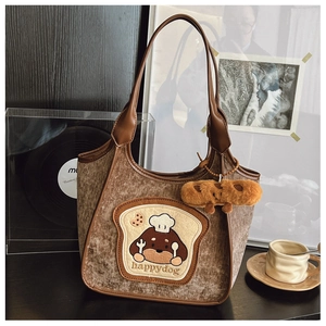Detail of a brown corduroy tote bag featuring a cute cartoon dog toast embroidery