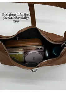 Top view of spacious caramel brown leather bag interior showing daily essentials storage