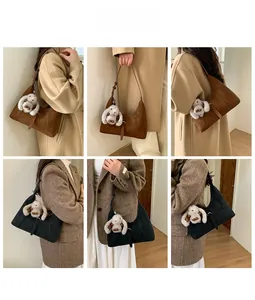 Detailansichten minimalistischer Halbmond-Schultertaschen mit Plüschhasen auf Mänteln