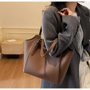 Close-up of the rich lychee grain texture on this spacious brown leather tote bag