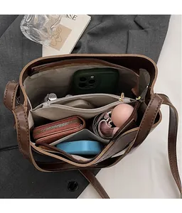 Detail view showing large storage capacity and interior compartments of the soft leather bag