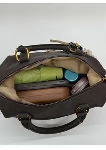 Interior view of brown Boston bag showing capacity for umbrella, wallet and phone