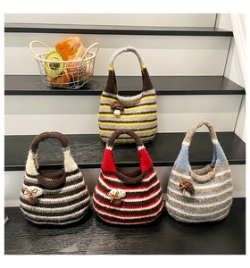 Detailed view of handmade knitted striped tote bags with 3D mushroom accents