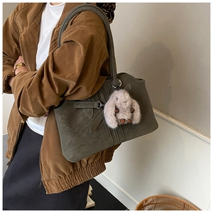 Retro dark green tote bag with plush bunny charm styled with an autumn winter outfit