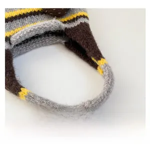 Close-up of tricolor striped knit fabric texture on the comfortable bag handle