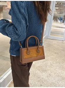 Rear view of model wearing a vintage brown patchwork crossbody bag with round buckles