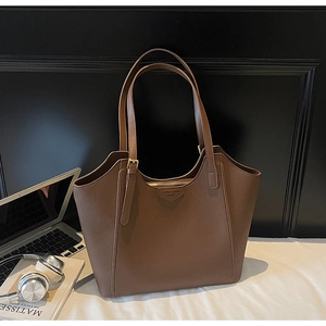 Detail of dark brown tote bag with premium lychee texture and adjustable metal buckle strap