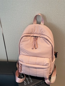 Fashionable pink puffer backpack with quilted design and letter straps for daily school use