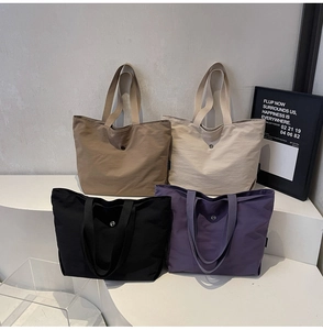 Minimalist large tote bags shown in brown, beige, black, and purple on display stands