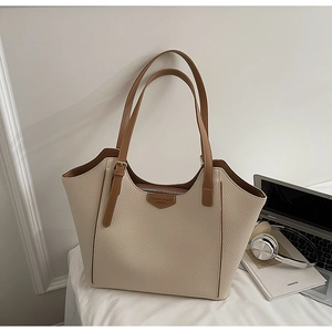 Detail of lychee pattern leather tote bag with silver zipper and spacious interior