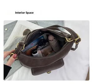 Interior space of a brown hobo bag showing large capacity for umbrella and wallet