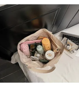 Beige canvas tote bag interior showing large capacity for daily essentials and tablets
