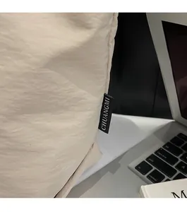 Close-up of CHUANGMI fabric tote bag featuring textured material and black brand label