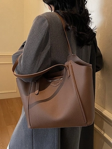 Brown lychee leather tote bag for women showing a stylish large capacity shoulder carry