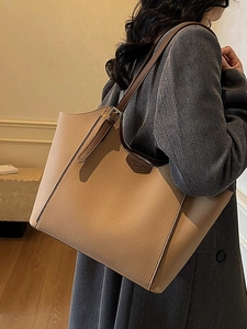 Large capacity leather tote bag in beige and dark brown with a long adjustable strap