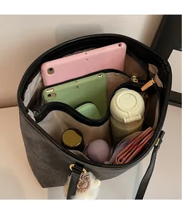 Detail view of spacious charcoal tote bag showing multi-compartment interior and storage capacity