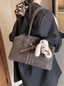 Retro dark coffee tote bag with plush bunny charm shown on a black blazer outfit