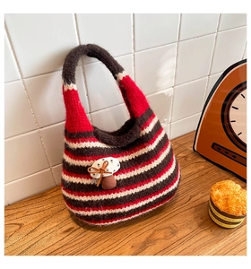 Detailed close-up of a striped hand-woven tote bag with a cute 3D mushroom charm