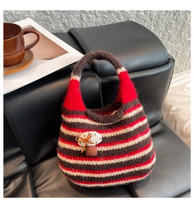 Detail of hand-knitted striped bucket bag featuring a 3D mushroom accent and bow knot