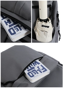 Close-up of gray textured backpack compartments showing storage for books and umbrella