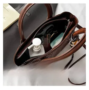 Detailed interior of dark brown woven handbag showing spacious storage with items