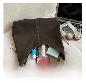 Interior view of large brown suede tote bag showing capacity for tablet and cosmetics