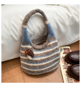 Detail of striped knitted bucket bag featuring a cute 3D mushroom patch and ribbon