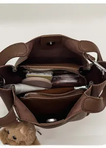 Overhead view of brown leather bucket bag interior showing spacious compartments and storage