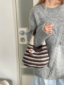 Striped knit bucket tote bag with mushroom charm and casual autumn style